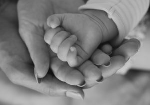 Bebis hand i vuxen hand
